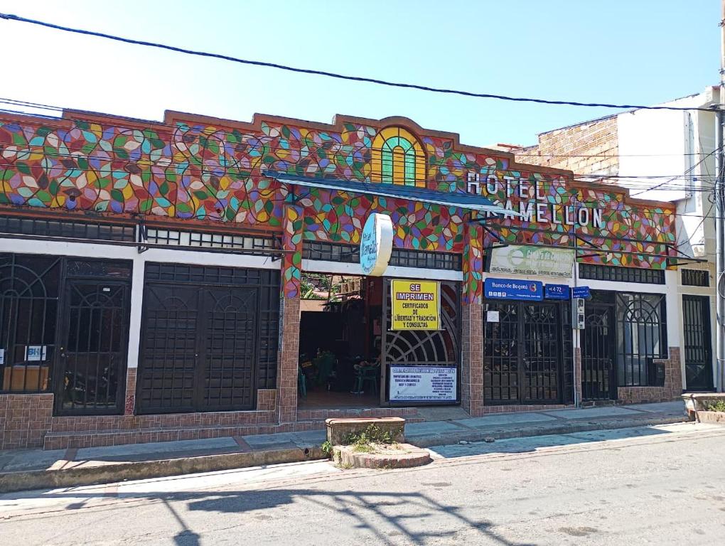 a building with a colorful facade on a street at Hotel KAMELLON in Estación El Salto