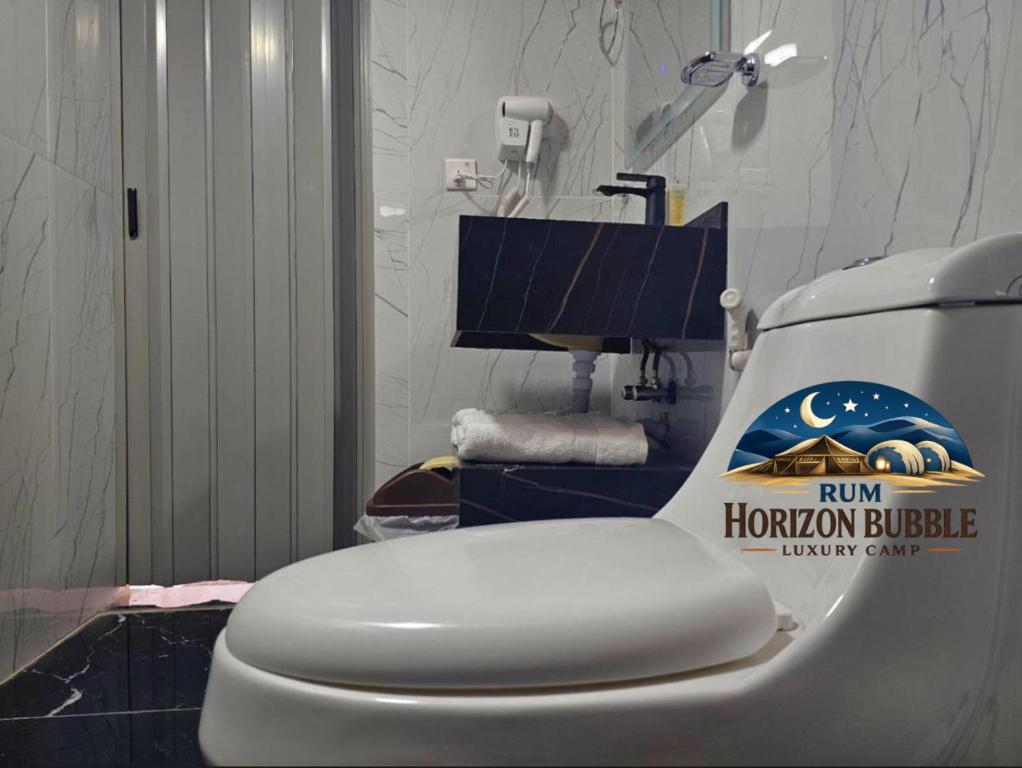 a bathroom with a toilet with a trump horizon bridge sticker on it at RAM HORlZON BUBBLE LUXURY CAMP in Wadi Rum