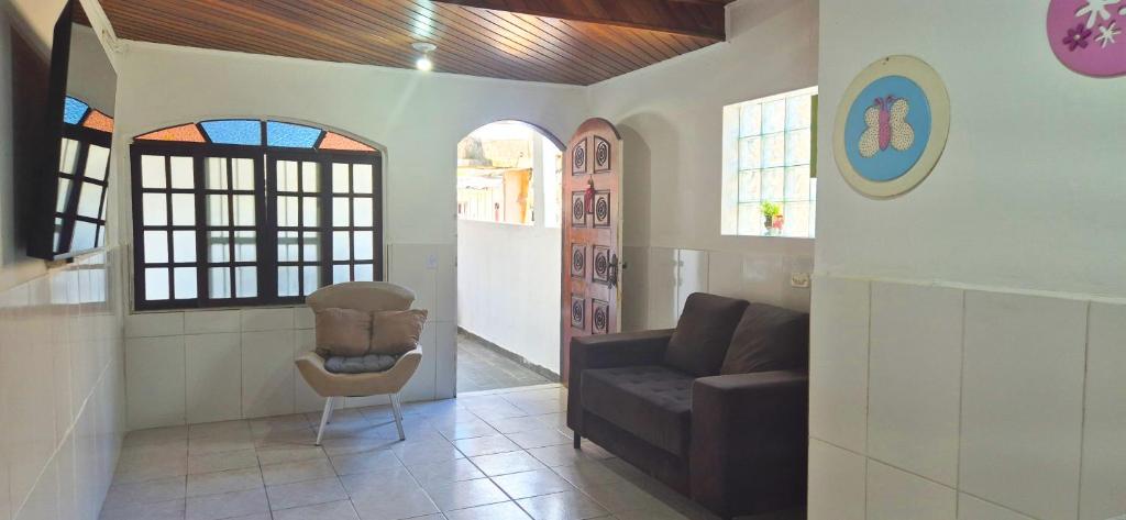 a living room with a couch and a chair at STO01 - Casa ampla em bairro tranquilo do Guarujá in Guarujá