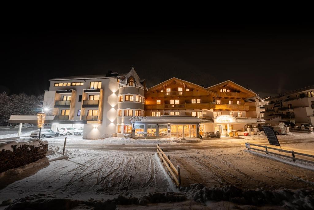 a large building in the snow at night at Hotel Garni Castel B&B in Ischgl