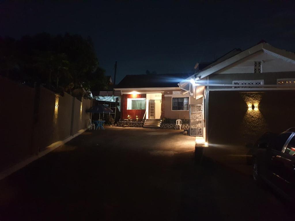 a house with lights on the side of it at night at KBK COMFORT Accommodation in Kampala