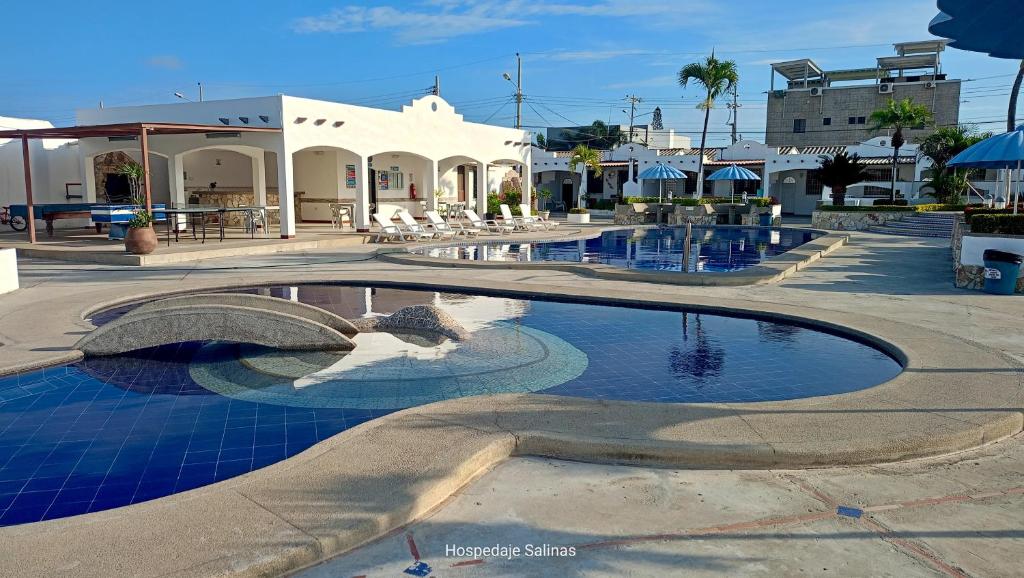 a swimming pool with blue tiles in a resort at Riveri Salinas V53 in Salinas