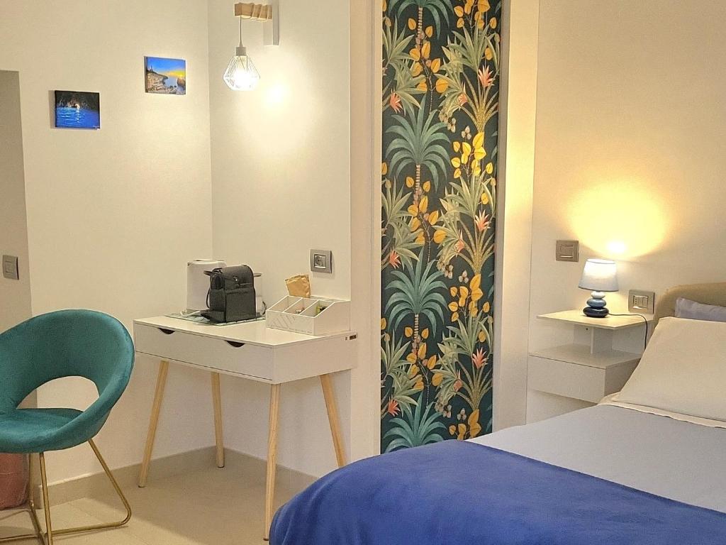 a room with a bed and a desk and a bed and a bed at L'Agrumeto in Anacapri