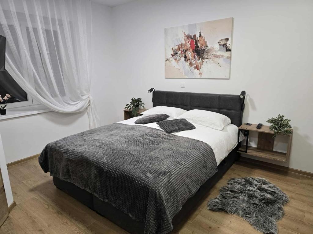 a bedroom with a bed with white sheets and pillows at Prenočišca Dany 3 in Dravograd
