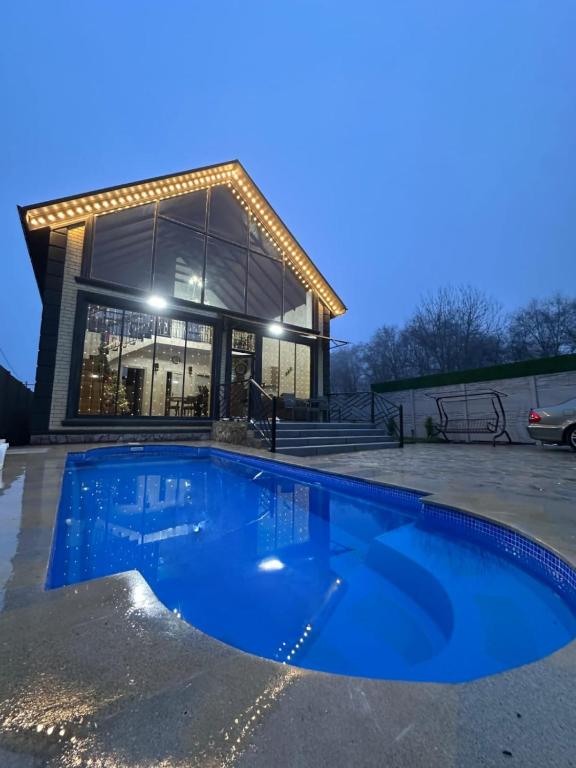 a house with a blue pool in front of a building at Sultan Villas A-Frame in Quba in Quba