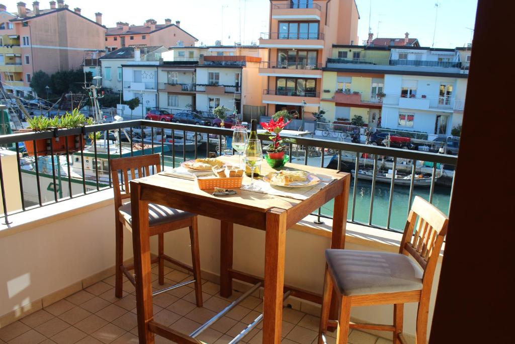 a table and chairs on a balcony with a view at AdryHouse in Grado