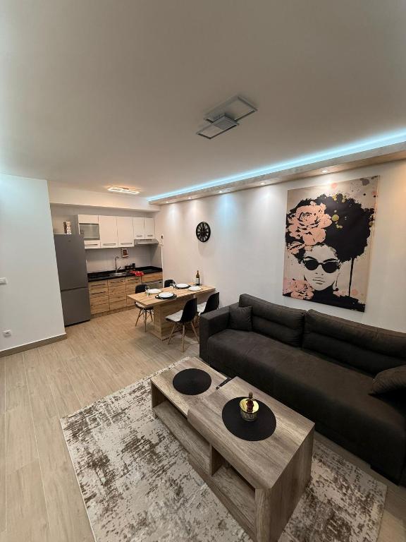ein Wohnzimmer mit Sofa und Tisch in der Unterkunft Hil Obrenovac in Obrenovac