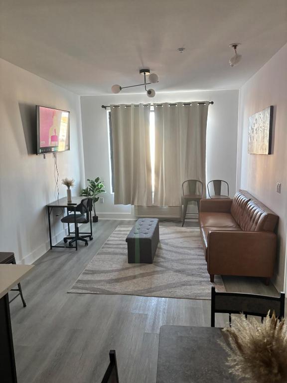 a living room with a couch and a table at Nice escape 8 min from EWR in Elizabeth