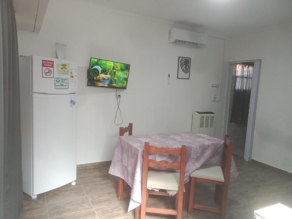 une cuisine avec une table et un réfrigérateur dans l'établissement Departamento Doña Elba, à Río Colorado