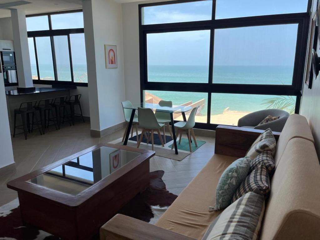 a living room with a couch and a table at Villa Regia in Poponguine