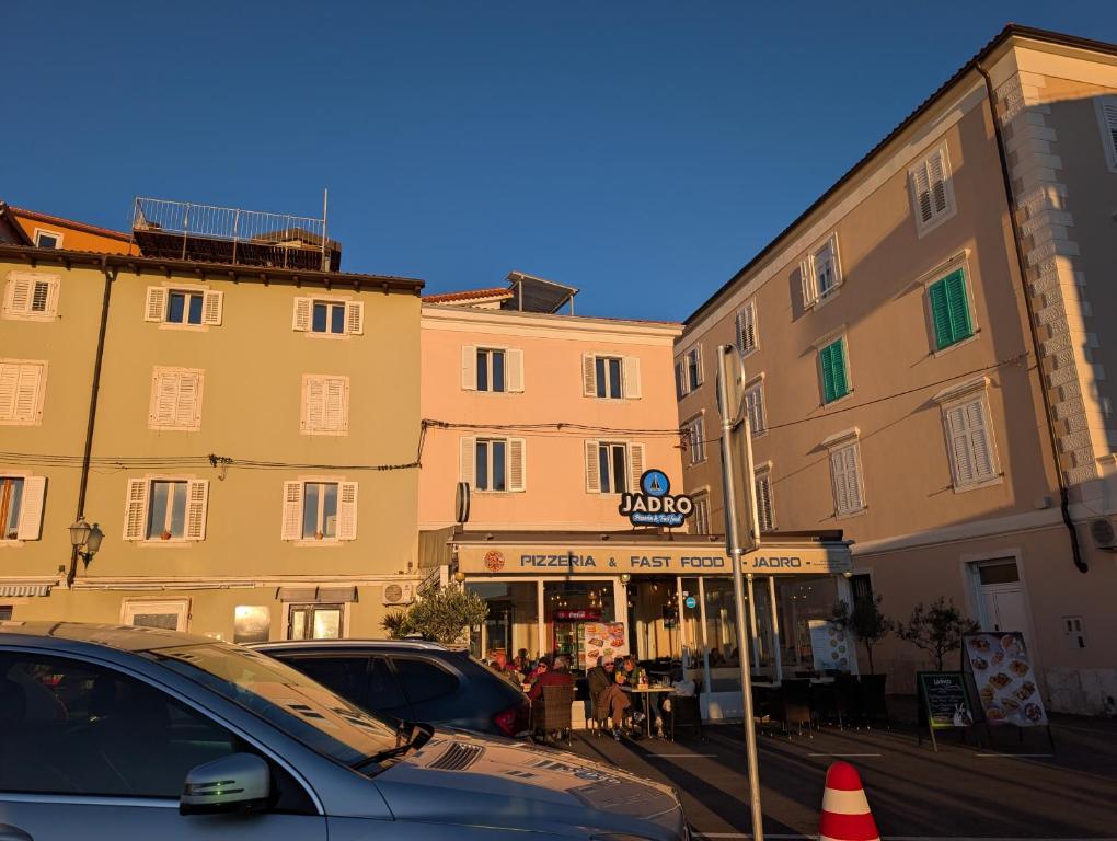 a car parked in front of a building at Apartmaji Trije Valovi in Piran