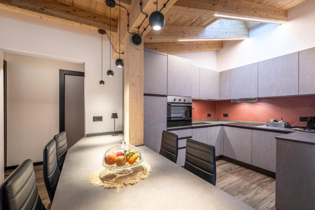 a kitchen with a table with a bowl of fruit on it at - Piz Boe - Canazei center app. in Canazei