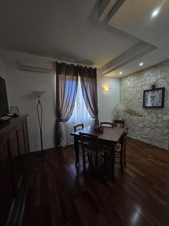 a dining room with a table and chairs and a stone wall at Narni Come a casa dei nonni in Fiaiola