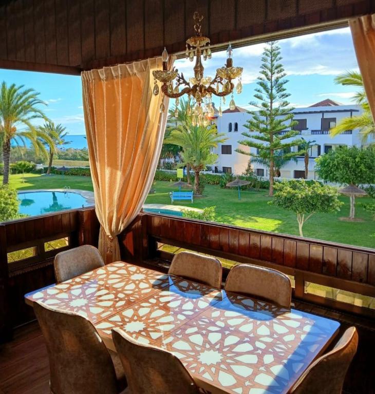 a dining room with a table and chairs and a large window at Ray CaboNegro Sea & Pool View in Cabo Negro