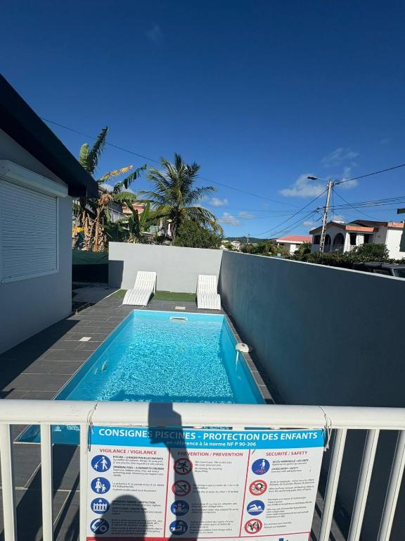 a swimming pool on the balcony of a house at Villa JOSAMY Charmante Villa avec Piscine à Deux Pas de la Mer in Sainte-Luce