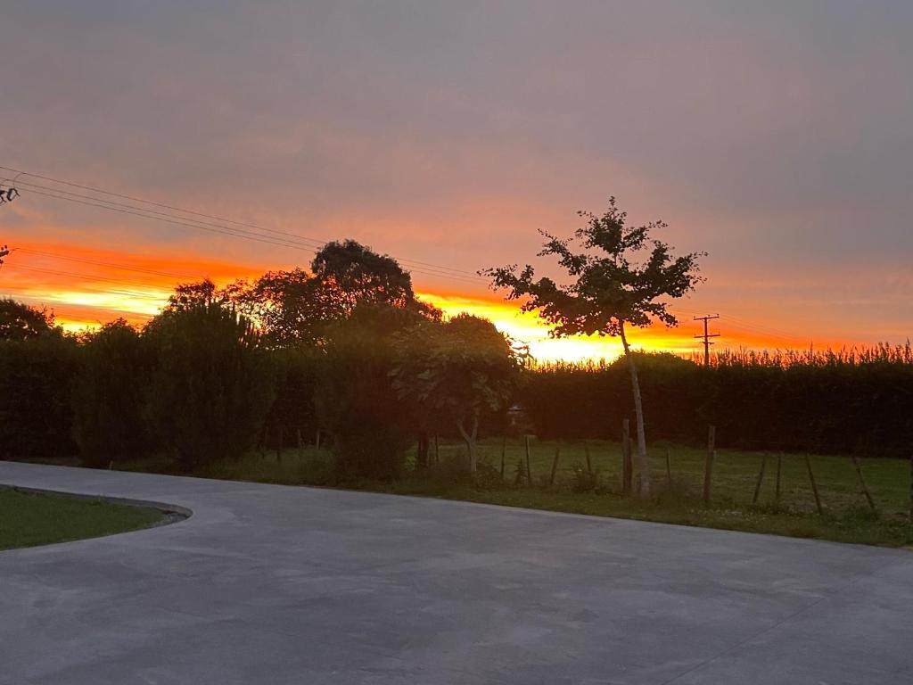an empty road with a sunset in the background at Self check-in double or single rooms in guests house in Te Miro