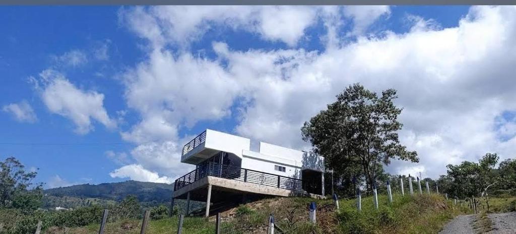 a house sitting on top of a hill at Supernova Glamping in Macanal