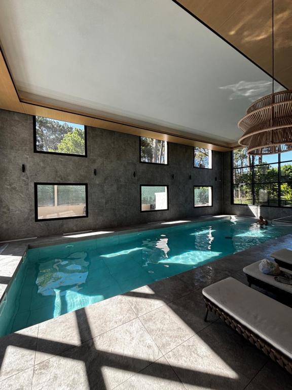 a swimming pool in a house with windows at Sea Garden Tower 2 in Punta del Este