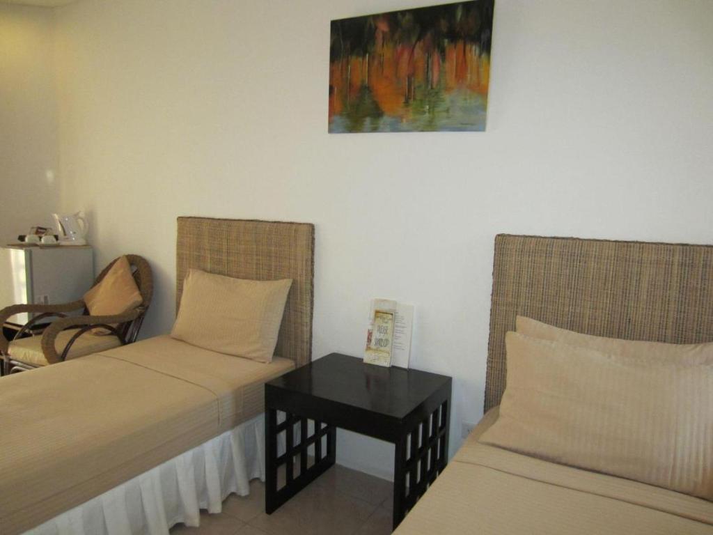 Postel nebo postele na pokoji v ubytování Boracay White Coral Hotel