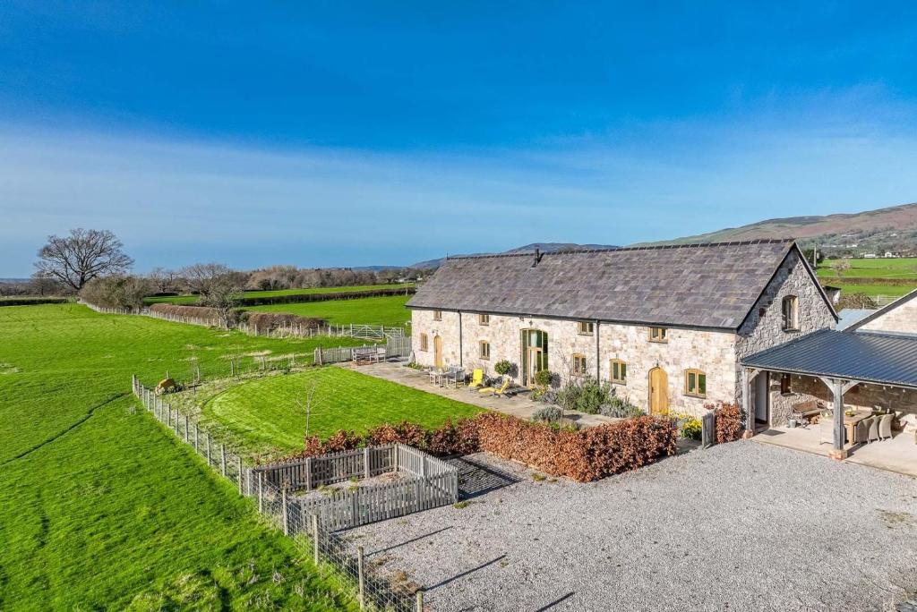 an aerial view of a stone house with a yard at The-Longbarn in Ruthin