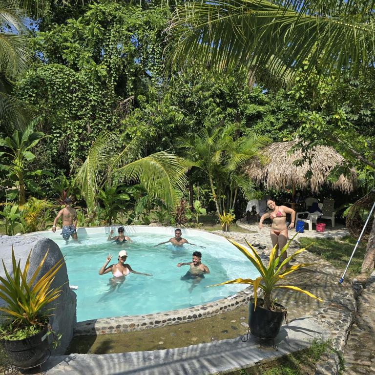 a group of people in a swimming pool at Magic Green Dentro del Parque Tayrona in El Zaino