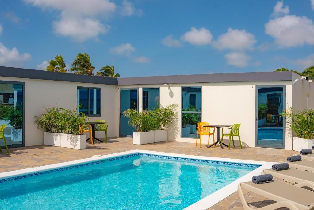 a house with a swimming pool and a patio at Mosch Apartments in Noord