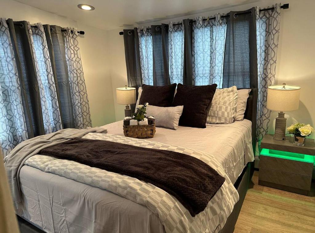 a bedroom with a large bed with blue curtains at Private Garden Suite in Bayshore in Bay Shore