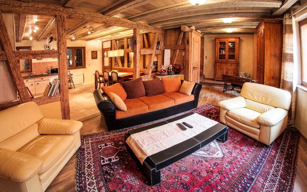 a living room with two couches and a table at Maison de la Fraternité in Ribeauvillé