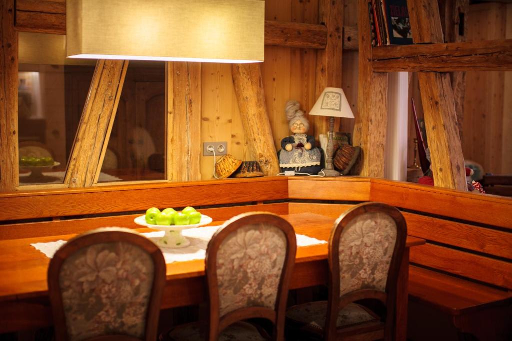 a dining room table with a bowl of fruit on it at Maison de la Fraternité in Ribeauvillé
