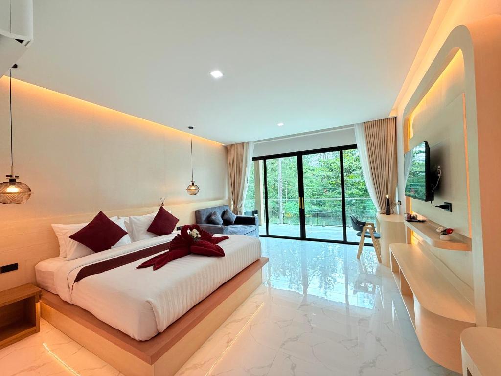a bedroom with a large bed and a television at Pure Sand Lanta Resort in Ko Lanta