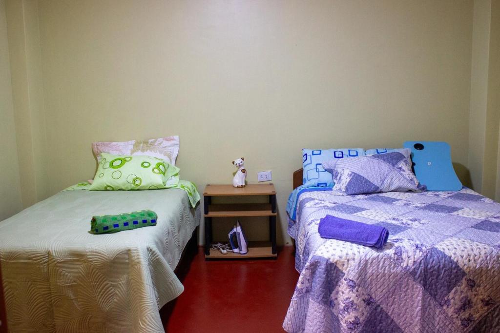 Giường trong phòng chung tại Posada del Carmen