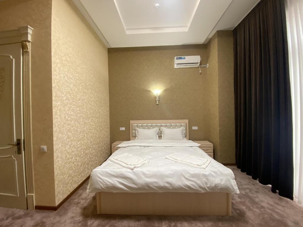 Postel nebo postele na pokoji v ubytování Violet Hotel