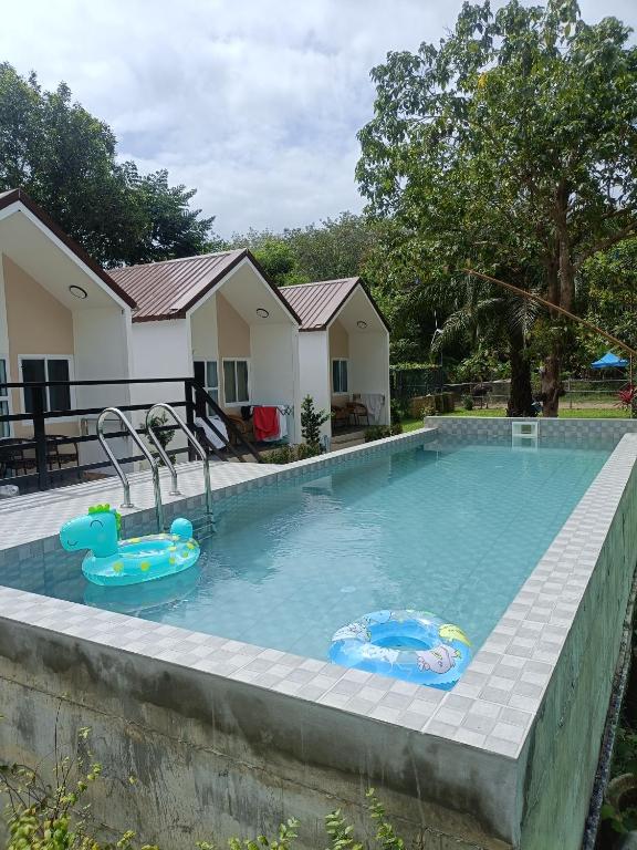 a swimming pool with two inflatables in a house at Mumzai House 2 in Ko Muk