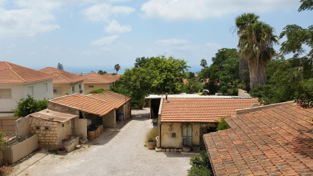 a group of houses with red roofs and trees at Smadar-Inn in Zikhron Ya‘aqov