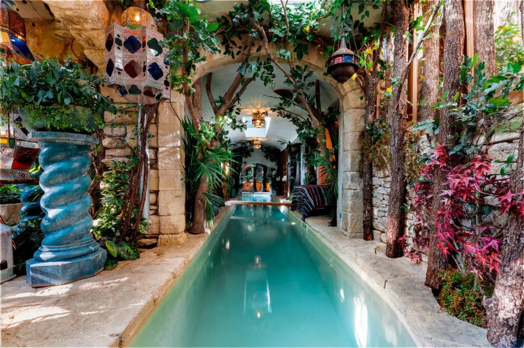 una piscina coperta in un edificio con piante di Rock House Pool & Authentic 17th-Century Home a Goult