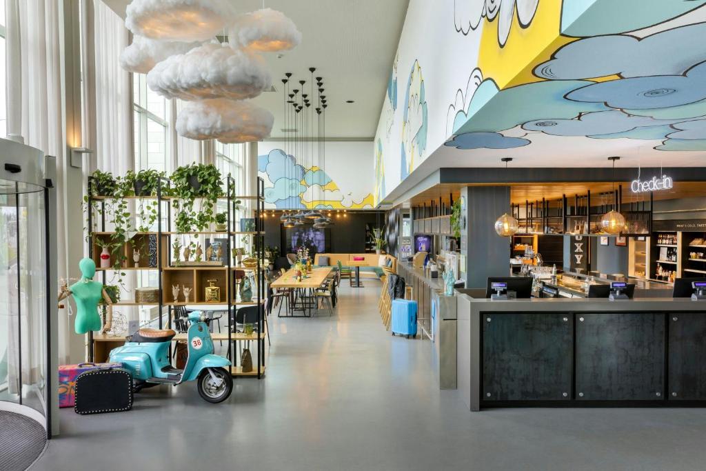 a shopping mall with a scooter parked in the middle at Moxy Milan Malpensa Airport in Case Nuove