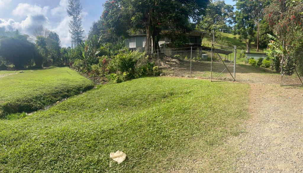a yard with a field of grass with a football goal at GOROKA Home Stay in Goroka