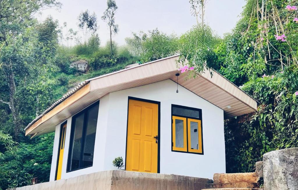 a small house with orange and yellow doors at White Monkey Dias Rest in Haputale