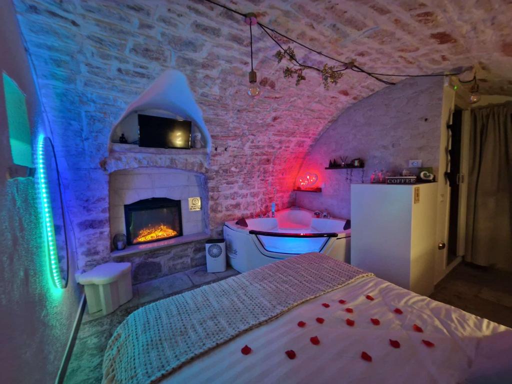 een slaapkamer met een open haard en een bed in een kamer bij Soffio di Pietra in Castellana Grotte