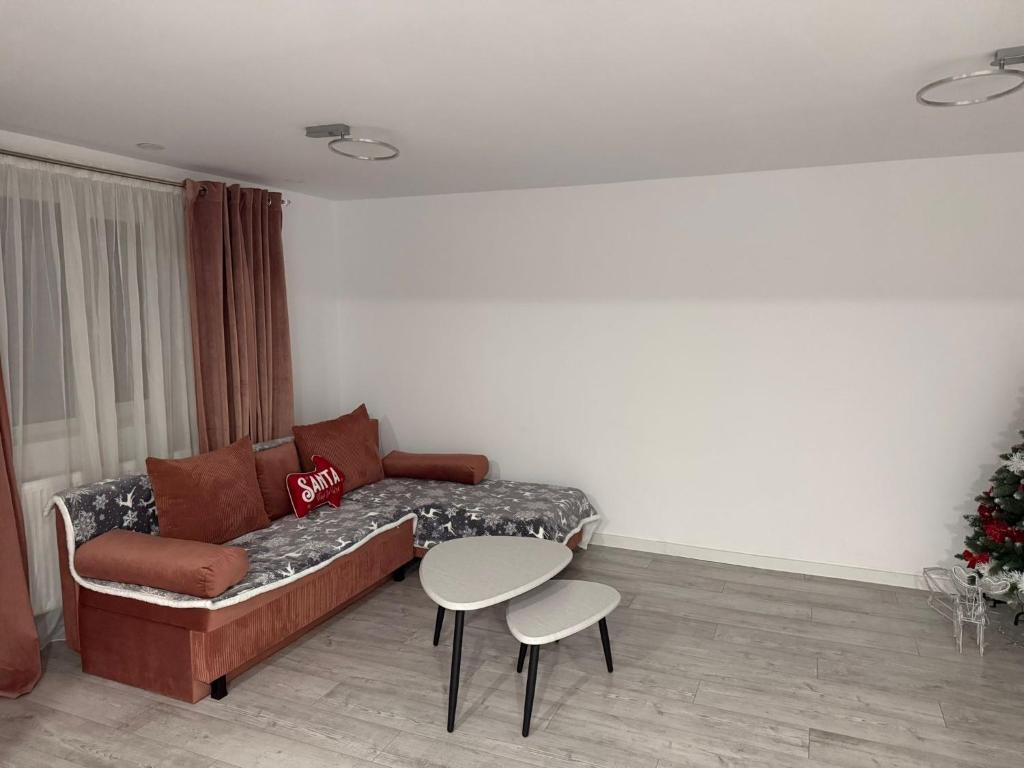 een woonkamer met een bank en een tafel bij Lad Petite Maison in Craiova