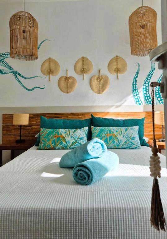 a bedroom with a bed with two towels on it at Villa detente 1 in Saint Gabriel