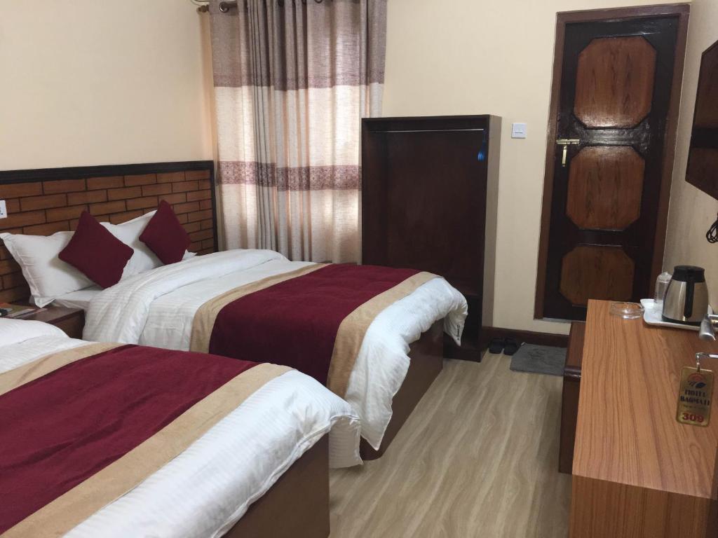 Postel nebo postele na pokoji v ubytování Hotel Bagmati