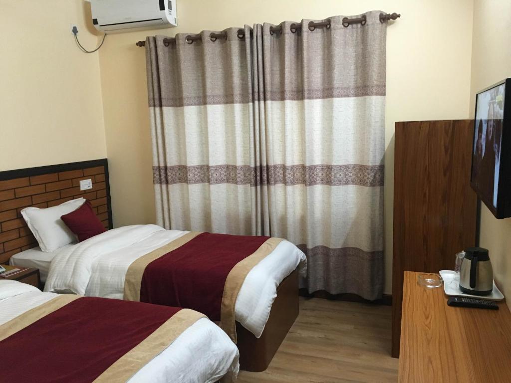 Postel nebo postele na pokoji v ubytování Hotel Bagmati