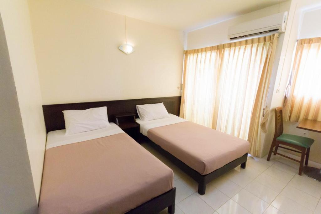 Postel nebo postele na pokoji v ubytování Mont Talay Hotel
