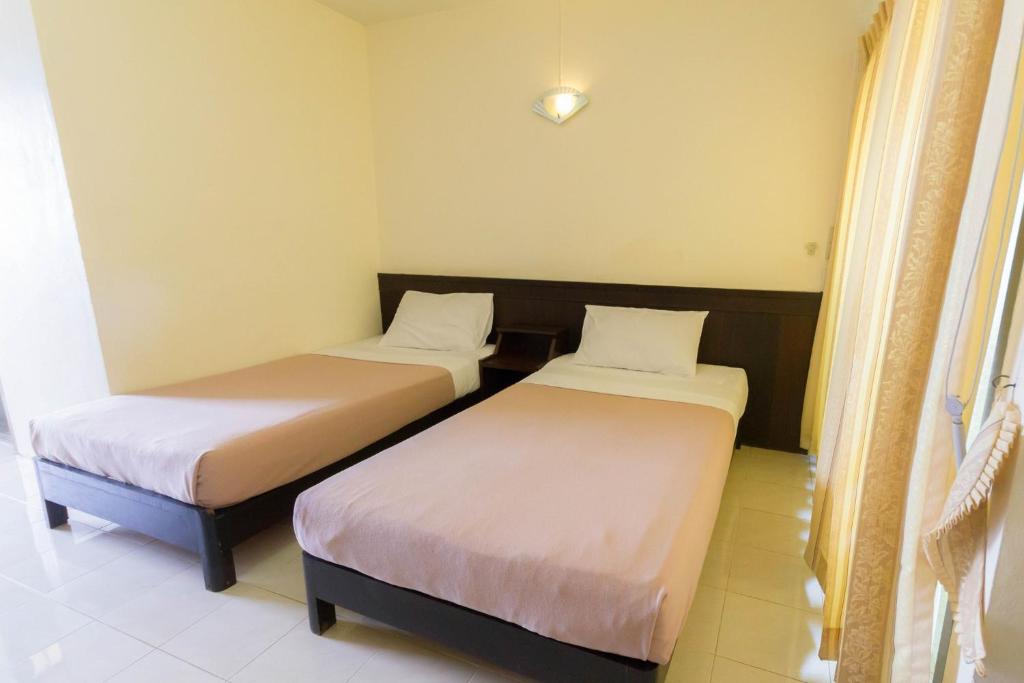 Postel nebo postele na pokoji v ubytování Mont Talay Hotel