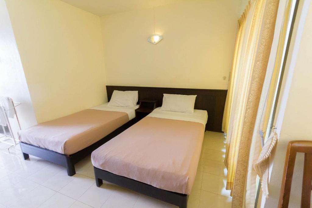 Postel nebo postele na pokoji v ubytování Mont Talay Hotel