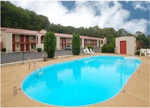a large blue swimming pool in front of a building at Americas Best Value Inn Cartersville in Cartersville