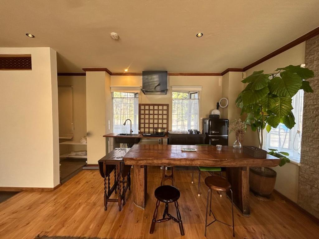 a kitchen with a large wooden table in a room at hayama satoyado in Hayama