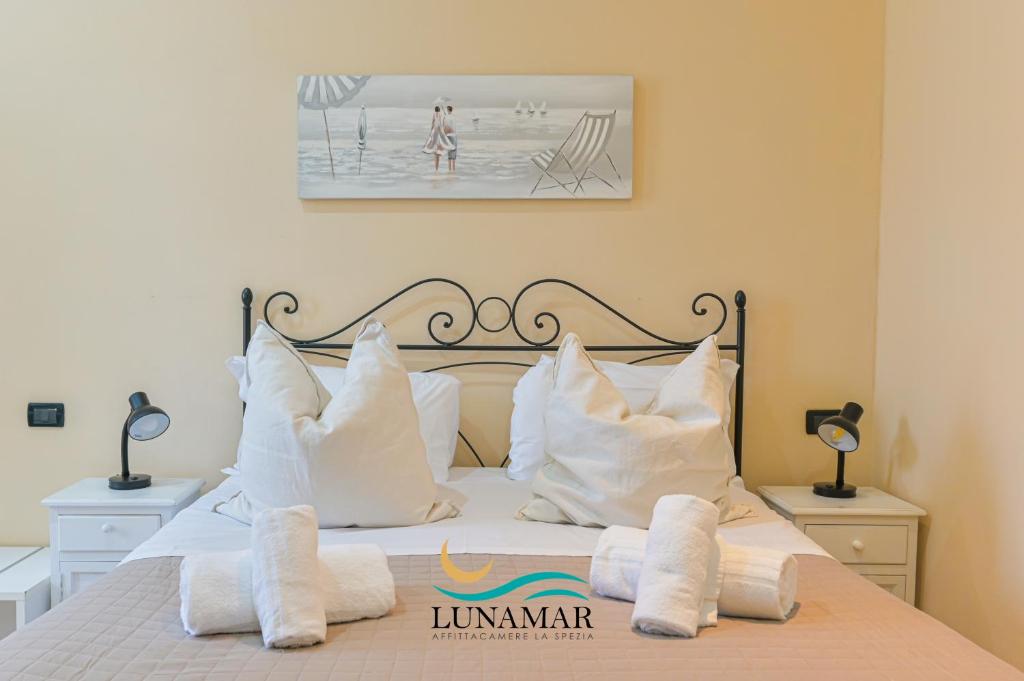 a bedroom with a bed with white pillows at Affittacamere Lunamar in La Spezia