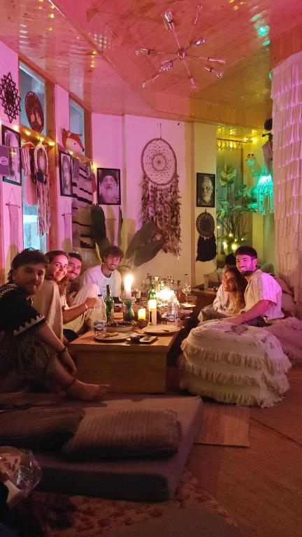 a group of people sitting on beds in a room at Buddha house 2 in Kasol